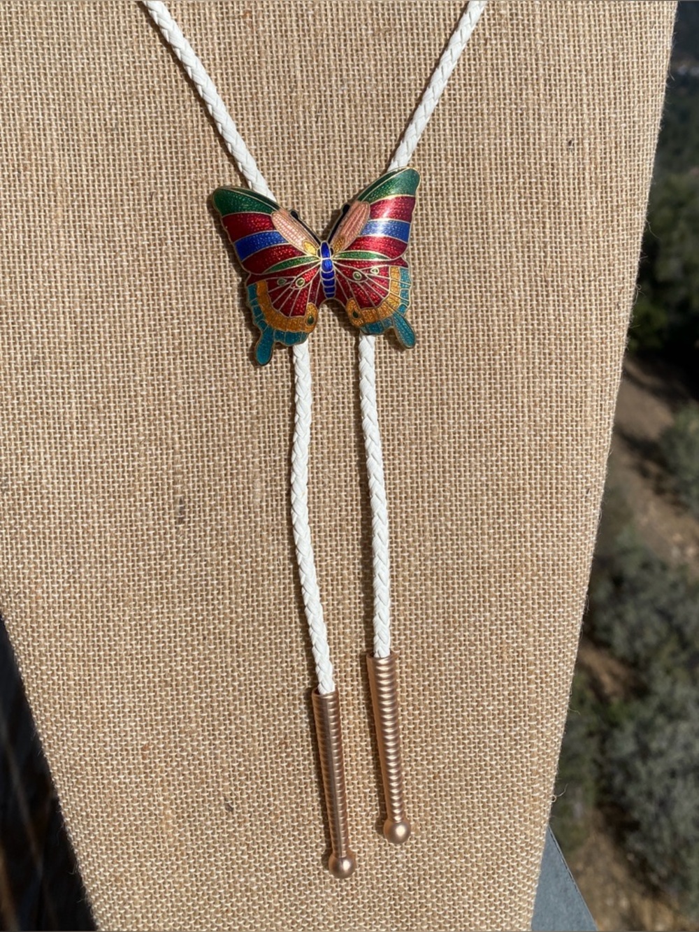 Bolo tie repurposed butterfly cloisonné belt buckle, new cord and tips.